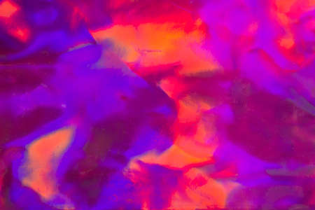 Trendy holographic foil texture background in satorated neon pink violet and orangecolors. Neon colored leather texture backdrop for your design.の写真素材