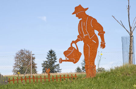 Gardeners figure pours flowersの写真素材