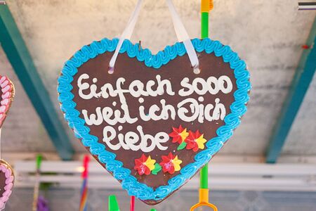 Gingerbread heart in german tradition christmas market. Text translation "just because i love you"の写真素材