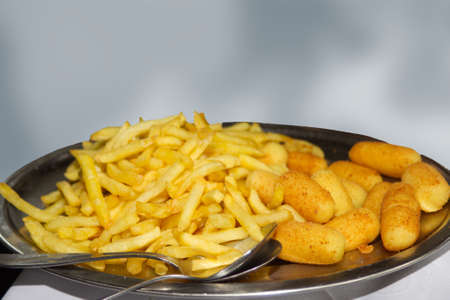 French fries and croquettes on plate in restaurant isolatedの写真素材