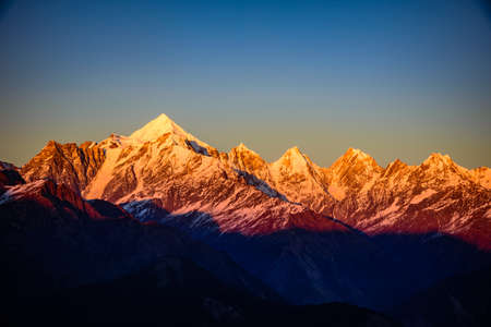 Panoramic view during sunset over snow cladded Panchchuli peaks falls in great Himalayan mountain range from Khalia top trekk trail at small hamlet Munsiyari, Kumaon region, Uttarakhand, India.の写真素材