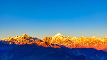 Panoramic view during sunset over snow cladded Panchchuli peaks falls in great Himalayan mountain range from small hamlet Munsiyari, Kumaon region, Uttarakhand, India.の写真素材