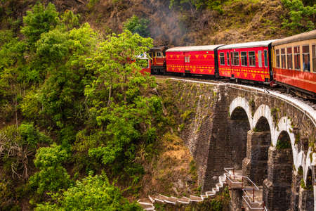 View from moving train on arch bridge over mountain slopes, beautiful view, one side mountain, one side valley. Toy train from Shimla to Kalka in Himachal Pradesh, Indiaのeditorial素材
