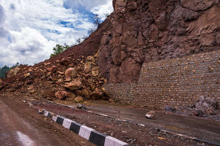 Rockfall blocked & causes traffic jam on Kalka Shimla expressway road during landslide after heavy rain due instable mountain slope by road widening blasting & deforestation.の写真素材