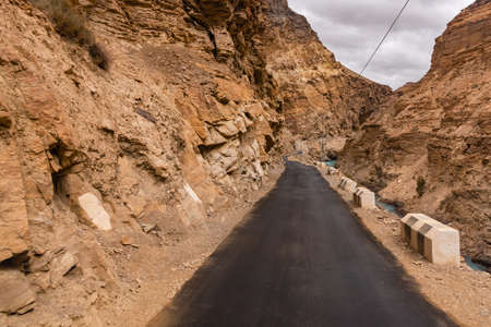 View from hilly mountain road Hindustan Tibet Road connecting Kaza city with Shimla state capital travelling through Himalayas mountains near Kalpa Kinnaur, Himachal Pradesh, India.の写真素材