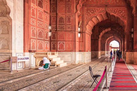 DELHI, INDIA â€“FEB, 2020: Muslim man having worship and praying on his knees praying for...