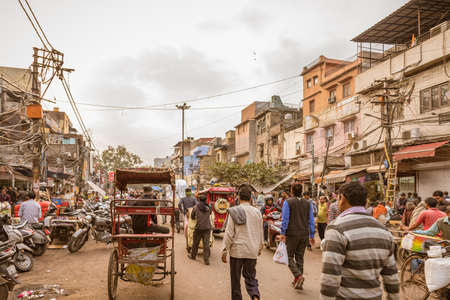OLD DELHI, INDIA - February 2018: Chaotic traffic in Chandni Chowk market, Street with people and...
