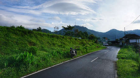 Beautiful road with grass cliffsの写真素材