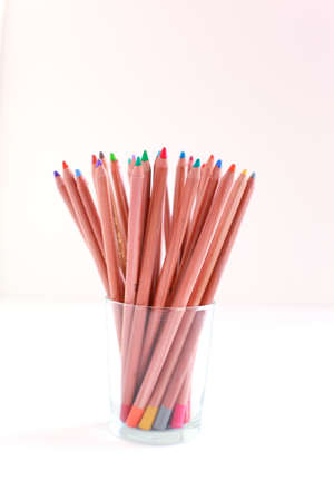 Colored pencils in the glass on the white background の写真素材