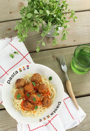 Pasta with meatballs and tomato sauce の写真素材