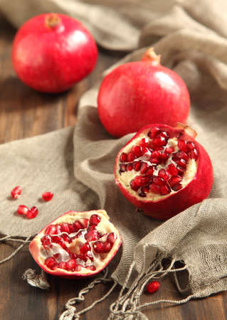 Pomegranates, whole and cut openの写真素材