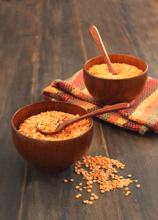 Bowl of red lentils on wooden backgroundの写真素材