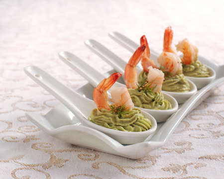 Avocado cream and shrimp in spoon の写真素材