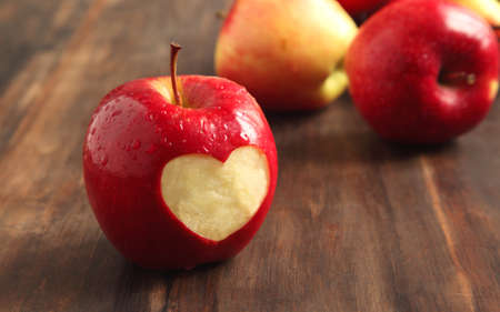 Red apple with a heart shaped cut-outの写真素材