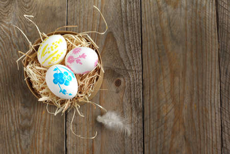 Colorful painted easter eggs in brown paper boxの写真素材