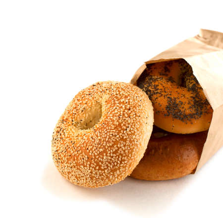 Assorted bagels in brown paper bagの写真素材