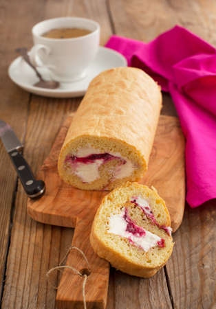 Homemade swiss roll with whipped cream and black currant jamの写真素材