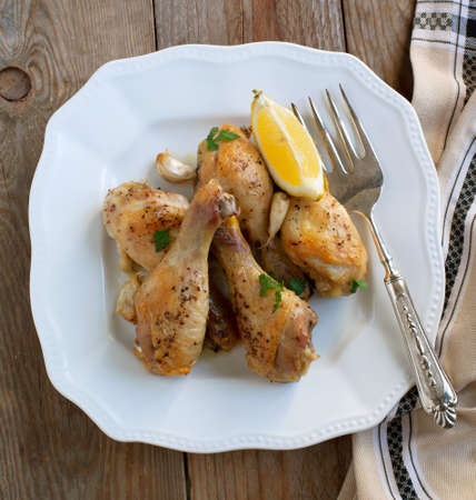 Roasted chicken legs with lemon and garlicの写真素材