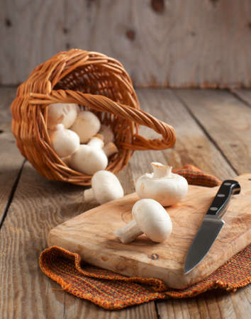 Fresh mushrooms on a wooden chopping boardの写真素材