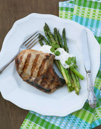 Grilled pork chops with grilled asparagusの写真素材