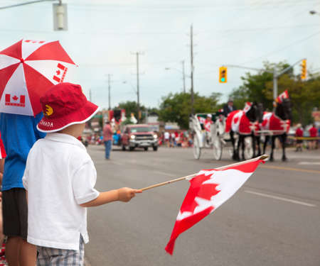 Boys watching a Canada Day parade  Aurora, Ontario, Canada のeditorial素材