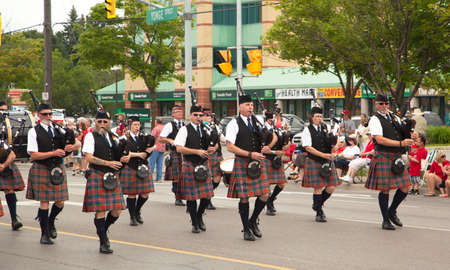 AURORA, ONTARIO, CANADA- JULY 1: Irishmen in their kilt playing their bagpipes during the Canada Day Parade at part of Young Street in Aurora, Canada on July 1, 2013のeditorial素材