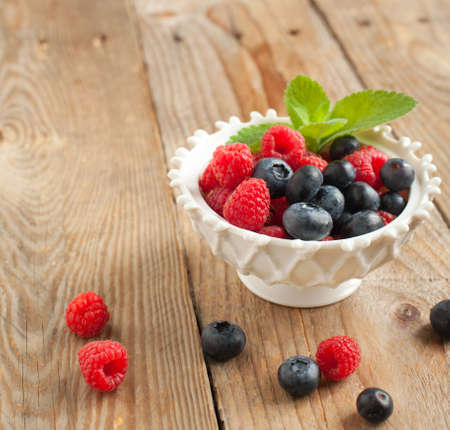 fresh raspberries and blueberriesの写真素材
