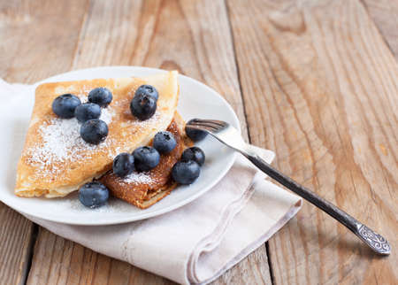 Crepes with blueberries and sugar powderの写真素材