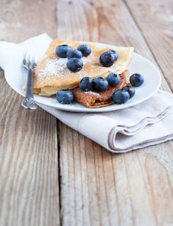 Crepes with blueberries and sugar powderの写真素材