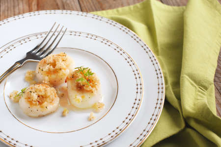 Baked scallops with herbal crumblsの写真素材