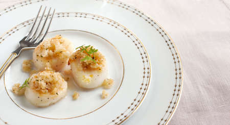 Baked scallops with herbal crumblsの写真素材