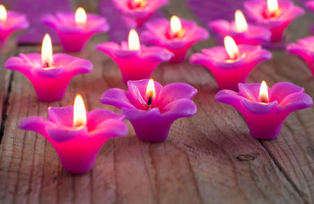 Group of burning candles on wooden background の写真素材