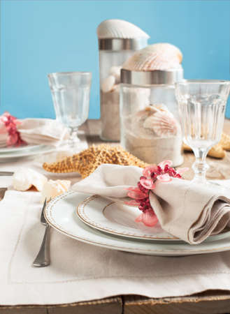Summer table setting decorated with starfish and sea shellの写真素材