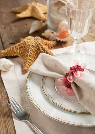 Summer table setting decorated with starfish and sea shellの写真素材