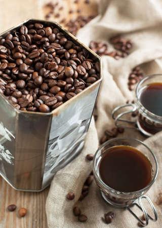 Coffee beans in old metal box and cups of coffeeの写真素材