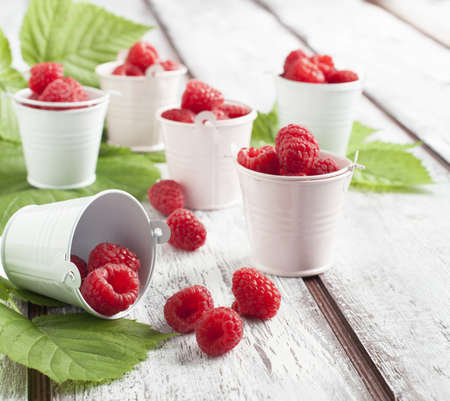 Fresh raspberries in small bucketの写真素材