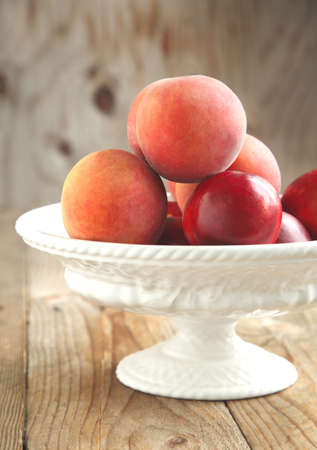 Fresh peaches in vaseの写真素材