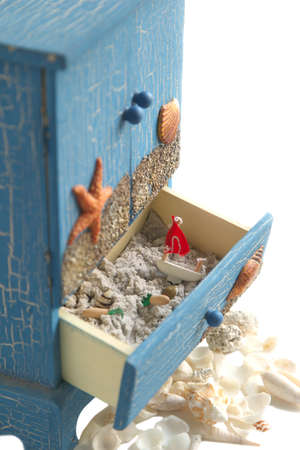 Sea decoration  Small decoration cabinet with sand and decoration small yacht and seashellsの写真素材