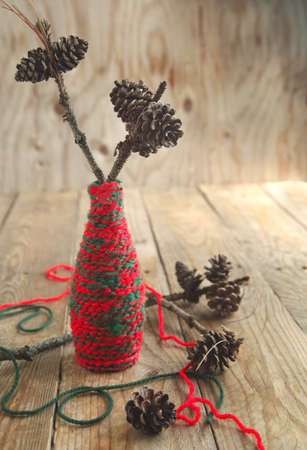 Christmas Composition with pine cones on the branch on wooden backgroundの写真素材