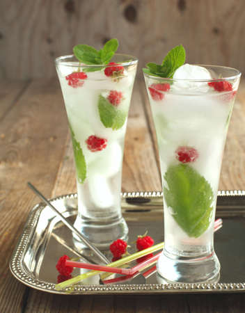 Glass of soda water with mint and raspberryの写真素材