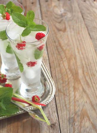 Glass of soda water with mint and raspberryの写真素材