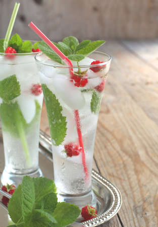 Glass of soda water with mint and raspberryの写真素材