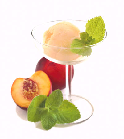 Peach ice cream in bowl isolated on white backgroundの写真素材