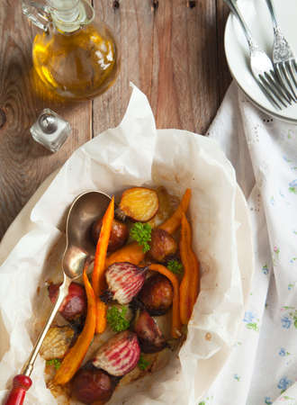 Baked beetroots and carrots in baking dishの写真素材
