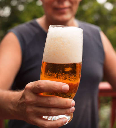 Man Holding a glass of Beerの写真素材