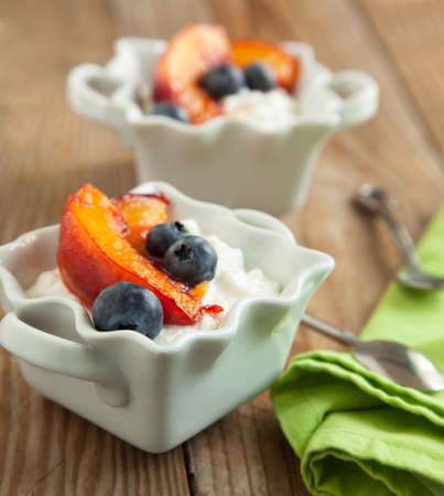 Cottage cheese with blueberries and caramelized peachesの写真素材