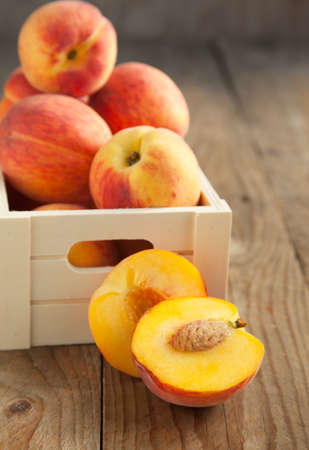 Fresh peaches in wooden boxの写真素材