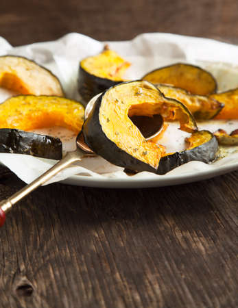 Baked pumpkin slices with herbs and olive oilの写真素材
