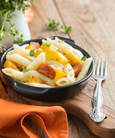 Pasta with cream sauce, italian sausage and pumpkinの写真素材