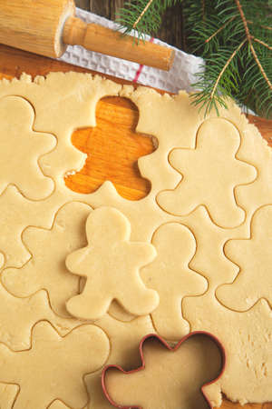 Cutting gingerbread cookies dough homemade for Christmasの写真素材